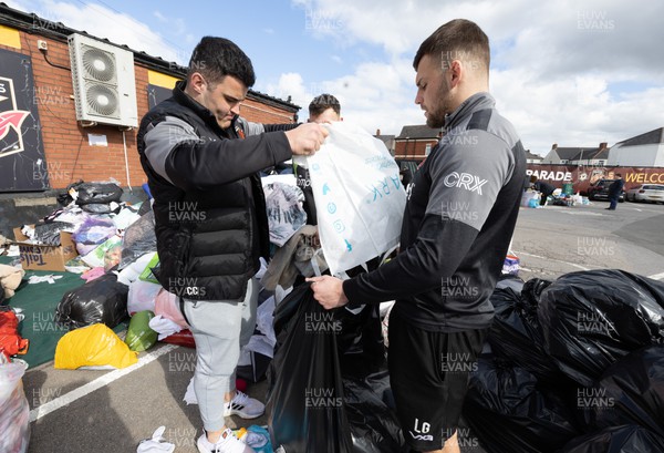 070322 Dragons Chris Coleman and Lennon Greggains along with the rest of the Dragons squad and staff join Newport County players and staff to help sort the large number of items donated to help those affected by the conflict in Ukraine