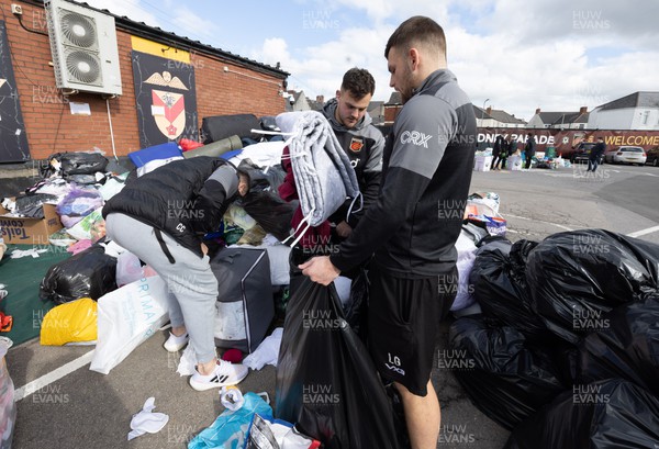 070322 Dragons and Newport County players and staff join forces to help sort the large number of items donated to help those affected by the conflict in Ukraine