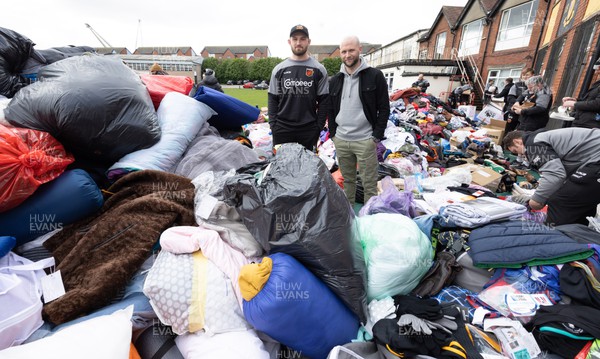 070322 Dragons captain Harri Keddie and Newport County manager James Rowberry along with players and staff join forces to help sort the large number of items donated to help those affected by the conflict in Ukraine