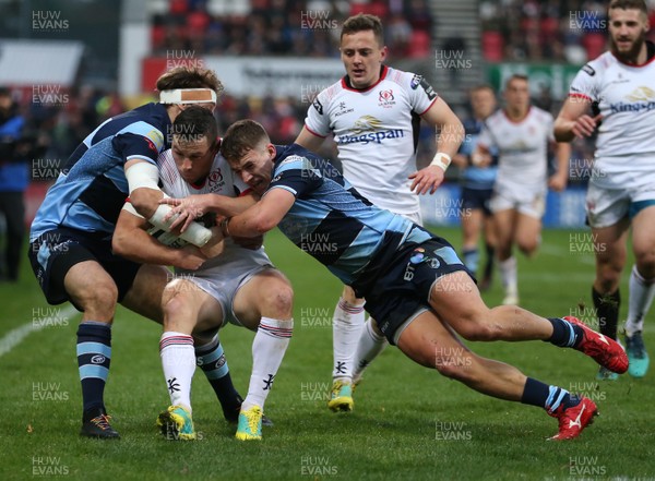 011218 - Ulster v Cardiff Blues - Guinness PRO14 -  Ulster John Cooney tackled by Cardiff Blues Aled Summerhill and Harri Millard
