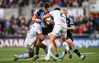 190424 - Ulster v Cardiff Rugby - United Rugby Championship - Cam Winnett of Cardiff is tackled by Will Addison, left, and Ethan McIlroy of Ulster