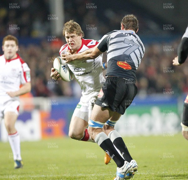 121012 Ulster v Castres - Heineken Cup - Andrew Trimble of Ulster is tackled by Yannick Caballero of Castres 