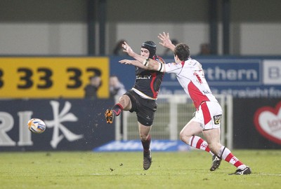 100212 - Ulster v Dragons - RaboDirect Pro 12Adam Hughes of Dragons kicks past Ian Whitten of Ulster