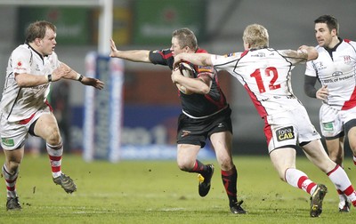 100212 - Ulster v Dragons - RaboDirect Pro 12Dragons' Steve Jones hands off Ulster's Callum Black as Nevin Spence makes the tackle