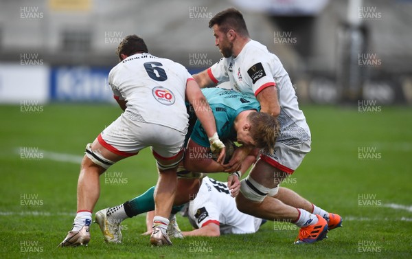 251020 - Ulster v Dragons - Guinness PRO14 - Joe Davies of Dragons is tackled by Sean Reidy, left, and Alan O'Connor of Ulster