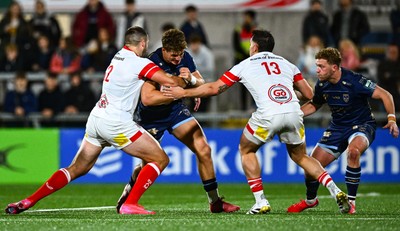 260925 - Ulster v Dragons RFC - United Rugby Championship - Joe Westwood of Dragons is tackled by Ulster players Stuart McCloskey, left, and James Hume 
