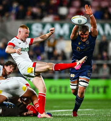 260925 - Ulster v Dragons RFC - United Rugby Championship - Nathan Doak of Ulster kicks clear despite the efforts of Shane Lewis-Hughes of Dragons 