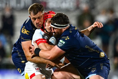260925 - Ulster v Dragons RFC - United Rugby Championship - Lowry of Ulster is tackled by Dragons players Ben Carter, left, and Wyn Jones