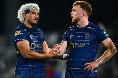 260925 - Ulster v Dragons RFC - United Rugby Championship - Aneurin Owen of Dragons, right, and team-mate Fine Inisi after their side's defeat