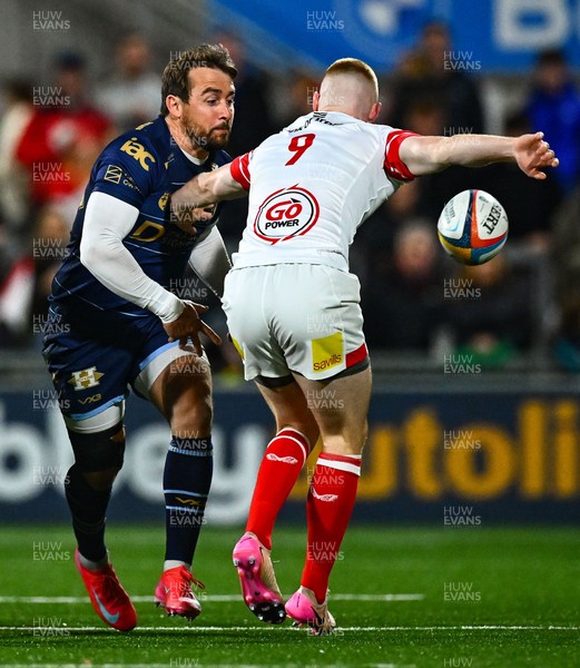260925 - Ulster v Dragons RFC - United Rugby Championship - Rhodri Williams of Dragons offloads the ball despite the efforts of Nathan Doak of Ulster