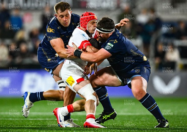 260925 - Ulster v Dragons RFC - United Rugby Championship - Michael Lowry of Ulster is tackled by Dragons players Ben Carter, left, and Wyn Jones