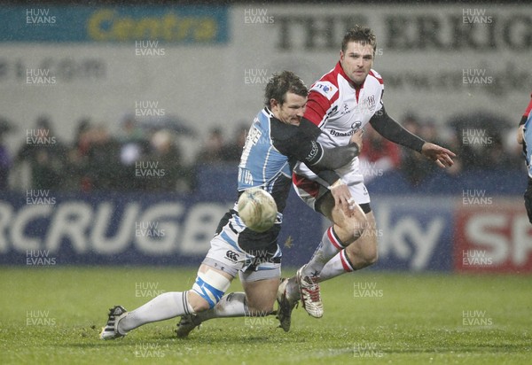 110113 Ulster v Glasgow - Heineken Cup - Jared Payne of Ulster kicks past Peter Murchie of Glasgow 