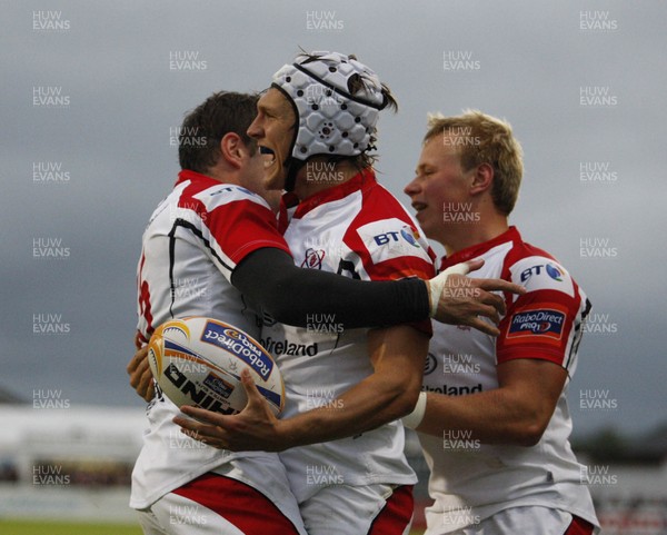 310812 - Ulster v Glasgow Warriors - RaboDirect PRO12 - Michael Allen of Ulster is congratulated by Jared Payne and Luke Marshall on scoring the first try