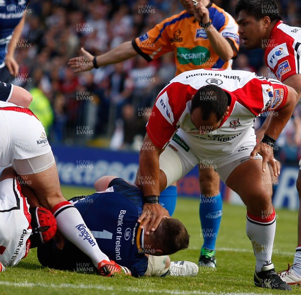 250513 - Ulster v Leinster - RaboDirect Pro 12 -  Cian Healy of Leinster grabs the leg of John Afoa of Ulster, who tries to escape his clutches 