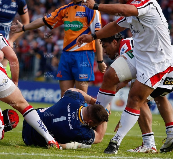 250513 - Ulster v Leinster - RaboDirect Pro 12 -  Cian Healy of Leinster grabs the leg of John Afoa of Ulster, who tries to escape his clutches  