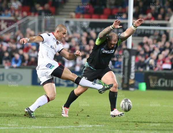 011016 Ulster v Ospreys -Ulster's Ruan Pienaar  kicks through as Paul James attempts the charge down