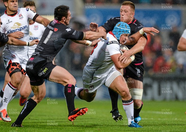 040915 - Ulster v Ospreys - Guinness Pro 12 -Luke Marshall of Ulster is tackled by Tom Grabham and Lloyd Evans of Ospreys 