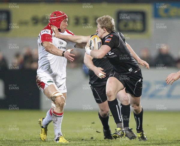 080213 Ulster v Ospreys - RaboDirect Pro12 - Ben John of Ospreys hands off Mike McComish of Ulster  