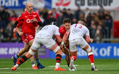 010325 - Ulster v Scarlets - United Rugby Championship - Macs Page of Scarlets is tackled by Ulster players  James McNabney, left, and James Hume