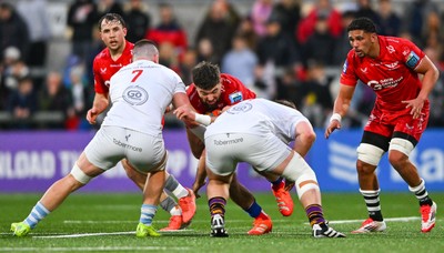 010325 - Ulster v Scarlets - United Rugby Championship - Max Douglas of Scarlets is tackled by Ulster players Nick Timoney, left, and Callum Reid