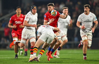 010325 - Ulster v Scarlets - United Rugby Championship - Max Douglas of Scarlets offloads the ball despite the tackle of Jacob Stockdale of Ulster