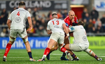 010325 - Ulster v Scarlets - United Rugby Championship - Ioan Nicholas of Scarlets is tackled by Ulster players James Hume, left, and Callum Reid