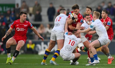 010325 - Ulster v Scarlets - United Rugby Championship - Johnny Williams of Scarlets is tackled by Ulster players, from left, Stuart McCloskey, Jack Murphy and Conor McKee