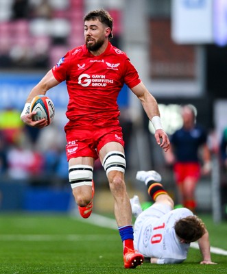 010325 - Ulster v Scarlets - United Rugby Championship - Max Douglas of Scarlets evades the tackle of Jack Murphy of Ulster