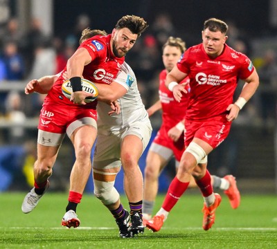 010325 - Ulster v Scarlets - United Rugby Championship - Johnny Williams of Scarlets is tackled by Callum Reid of Ulster