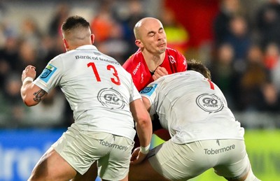 010325 - Ulster v Scarlets - United Rugby Championship - Ioan Nicholas of Scarlets is tackled by Ulster players James Hume, left, and Callum Reid