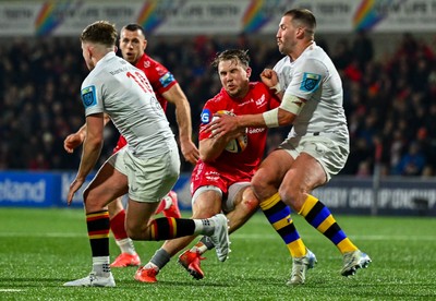 010325 - Ulster v Scarlets - United Rugby Championship - Ioan Llyod of Scarlets kicks is tackled by Stuart McCloskey of Ulster