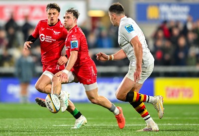 010325 - Ulster v Scarlets - United Rugby Championship - Ioan Llyod of Scarlets kicks on despite the attention of Jacob Stockdale of Ulster