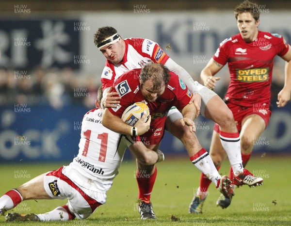 040113 Ulster v Scarlets - RaboDirect Pro 12 - Jacobie Adriaanse of Scarlets is tackled by  Craig Gilroy and Rob Herring of Ulster 