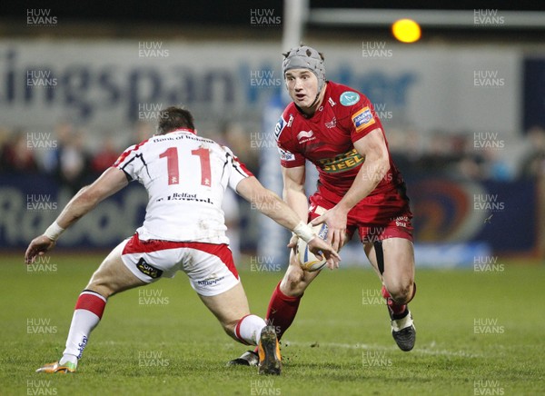 040113 Ulster v Scarlets - RaboDirect Pro 12 - Jonathan Davies of Scarlets offloads the ball before the tackle from Craig Gilroy of Ulster 