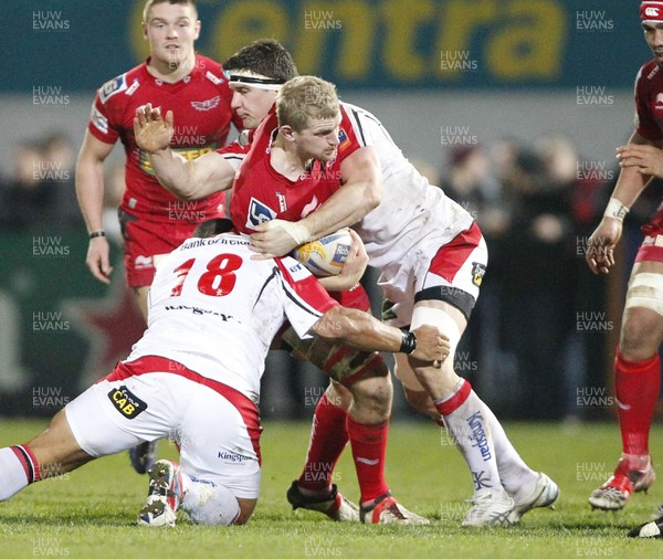 040113 Ulster v Scarlets - RaboDirect Pro 12 - Craig Price of Scarlets is tackled by John Afoa and Robbie Diack of Ulster 