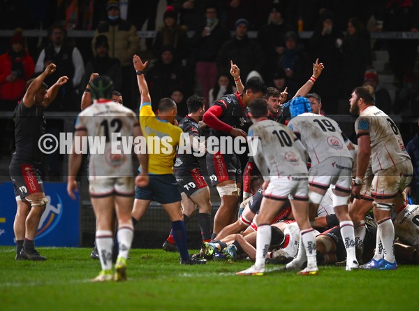 280122 - Ulster v Scarlets - United Rugby Championship - Scarlets players celebrate as Steff Thomas, hidden, goes over to score their side's second try