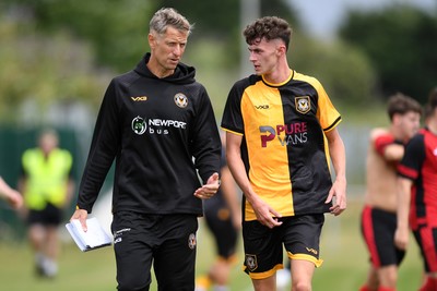 050725 - Undy Athletic v Newport County - Pre season Friendly - Newport County Manager, David Hughes speaks with Joe Thomas of Newport County at half time
