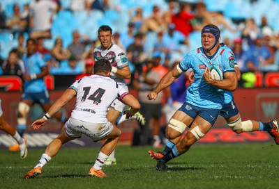 Luke Morgan of the Ospreys looking to tackle a charging Reinhardt Ludwig of the Vodacom Blue Bulls