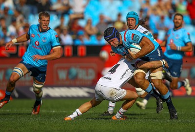 Luke Morgan of the Ospreys tackles Elrigh Louw (c) of the Vodacom Blue Bulls