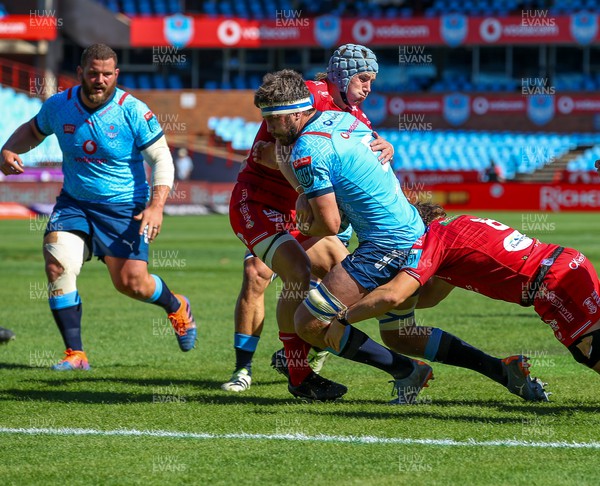 180322 - Vodacom Bulls v Scarlets - United Rugby Championship - Ben Williams of the Scarlets tries to stop Ruan Nortje of the Vodacom Blue Bulls from scoring his try