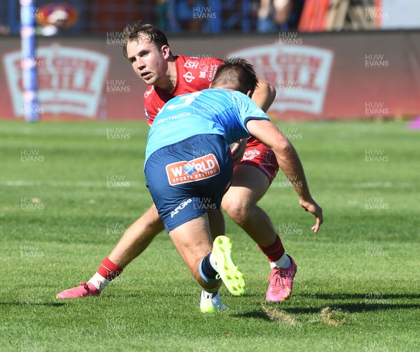 180322 - Vodacom Bulls v Scarlets - United Rugby Championship - Ioan Lloyd of the Scarlets takes on Wilco Louw