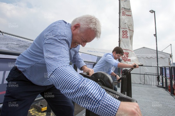 270518 - Volvo Ocean Race, Cardiff Bay -  First Minister Carwyn Jones and Huw Thomas, Leader of Cardiff City Council, take on the Musto grinder challenge