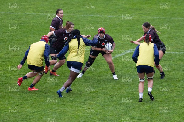 171023 - Wales Women and France Women combined training session - Donna Rose takes on the French defence during a combined training session at Rugby League Park in Wellington against France Women ahead of their first matches in WXV1
