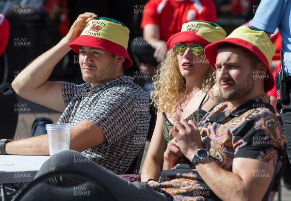 260621 - Wales fans react after watching Wales concede a goal in the first half of the Euro 2020 match between Wales and Denmark on a big screen at Cardiff Arms Park, Cardiff