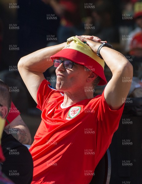 260621 - Wales fans react after watching Wales concede a goal in the first half of the Euro 2020 match between Wales and Denmark on a big screen at Cardiff Arms Park, Cardiff