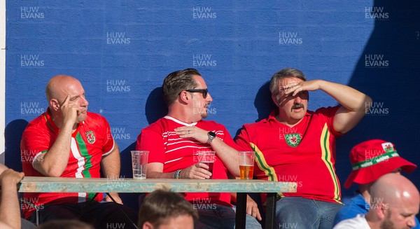 260621 - Wales fans react during the match as Denmark beat Wales 4-0 in their Euro 2020 match Fans watched the match on a big screen at Cardiff Arms Park, Cardiff