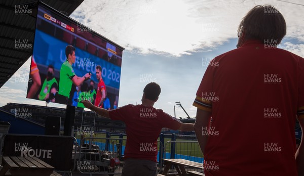 260621 - A Wales fan reacts as Denmark are awarded a fourth goal near the end of the Euro 2020 match between Wales and Denmark Fans watched the match on a big screen at Cardiff Arms Park, Cardiff