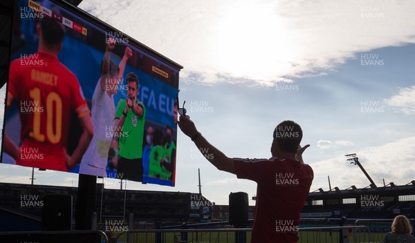 260621 - A Wales fan reacts as Denmark are awarded a fourth goal near the end of the Euro 2020 match between Wales and Denmark Fans watched the match on a big screen at Cardiff Arms Park, Cardiff