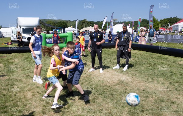 300523 - Wales Football manager Rob Page, left, and Wales U21 manager Matty Jones, watch young players at The Urdd National Eisteddfod in Llandovery
