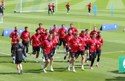 070617 - Wales Football Training Session - The Wales Squad warm up at the start of the training session ahead of the FIFA World Cup Qualifying match against Serbia